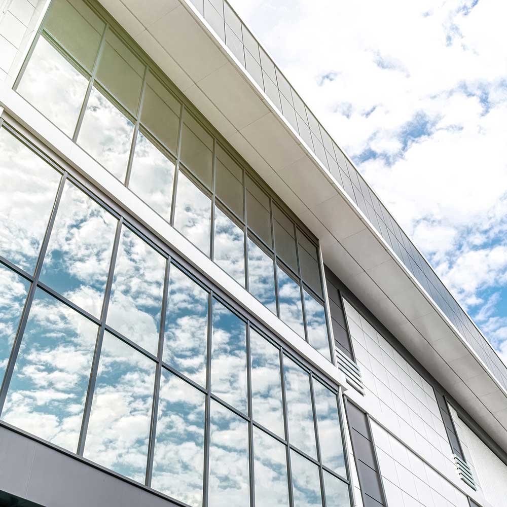 Modern office building against a lightly cloudy sky